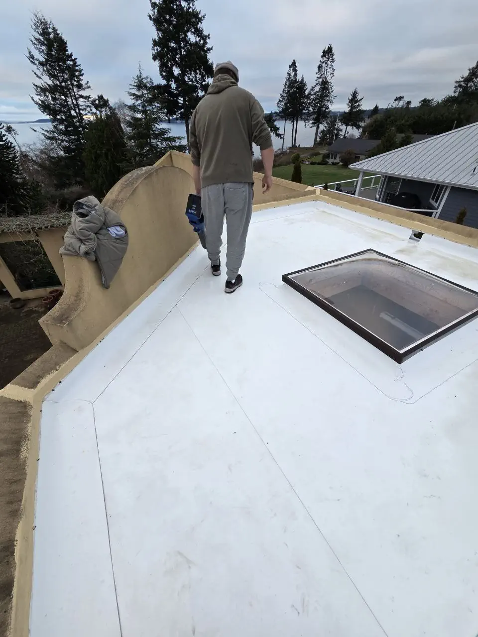 Licensed TPO roofers heat-welding membrane seams