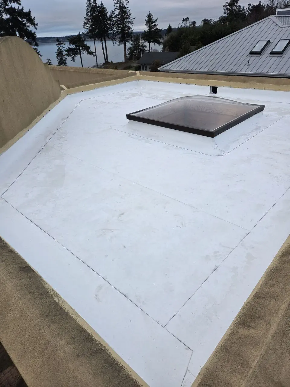 TPO roofing specialists inspecting a white membrane roof