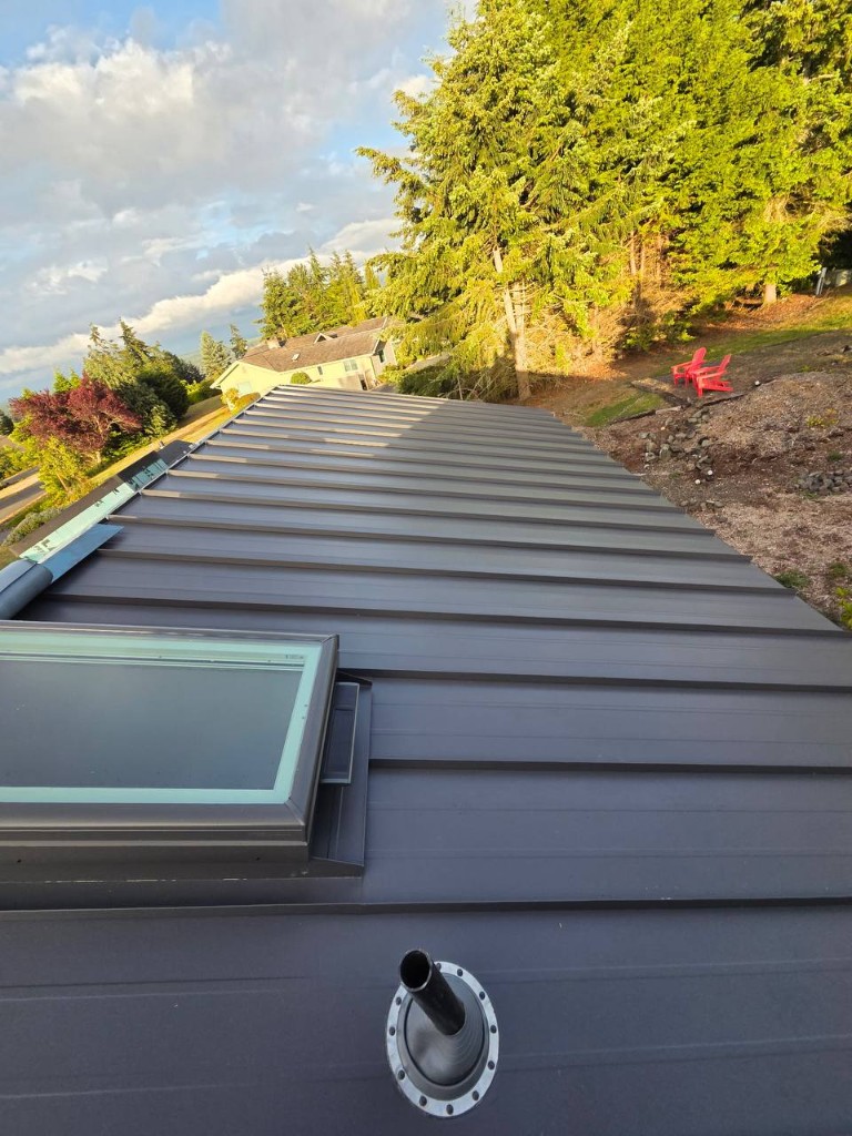 Standing seam metal roof valley detail with integrated skylight flashing