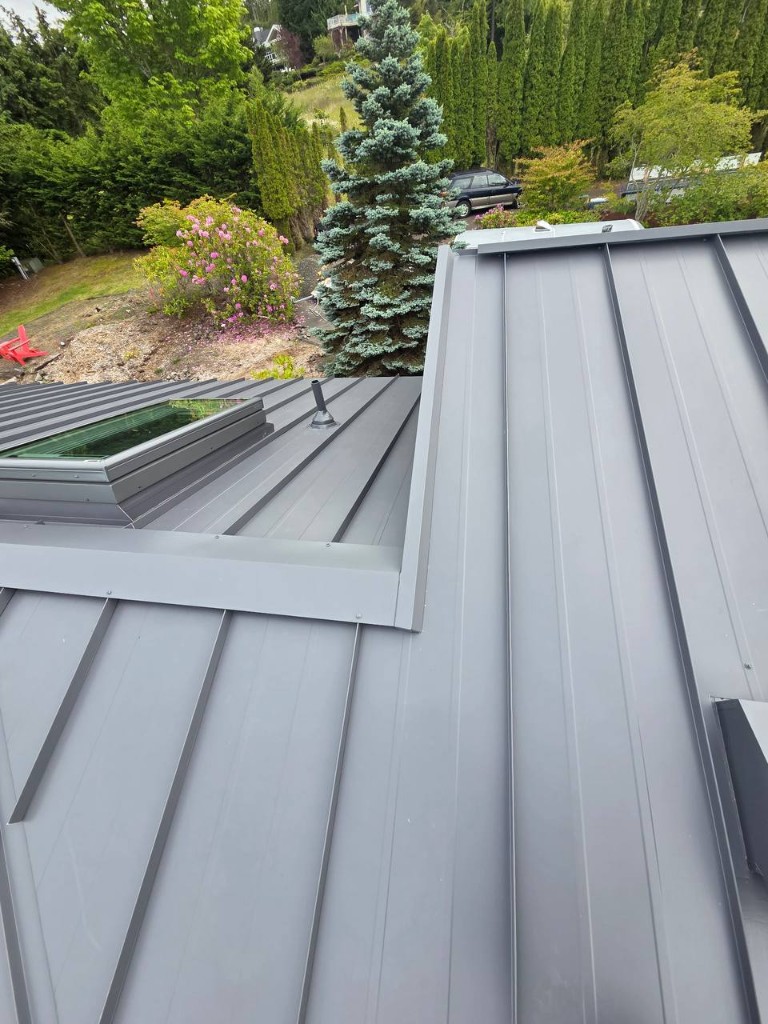 Metal roof crew working on ridge flashing with DeWalt tools on site