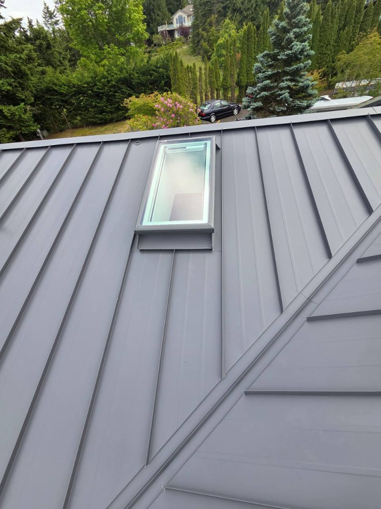 Metal roof installation showing underlayment and panel layout from roof level
