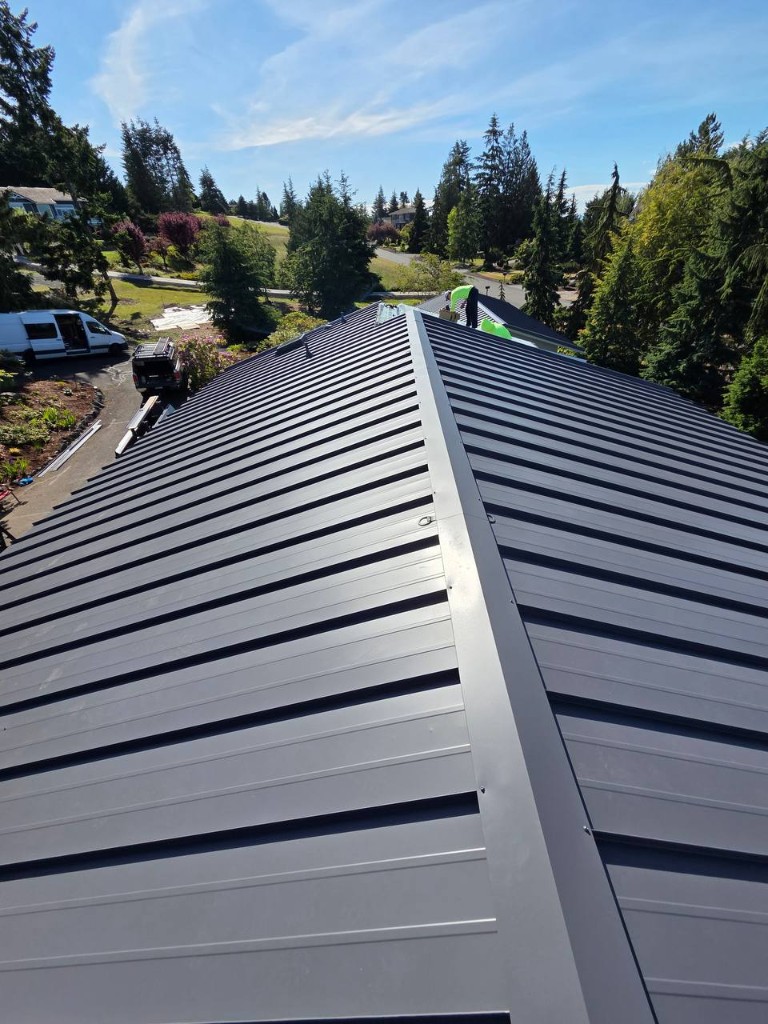Drone photo of charcoal standing seam metal roof with deck