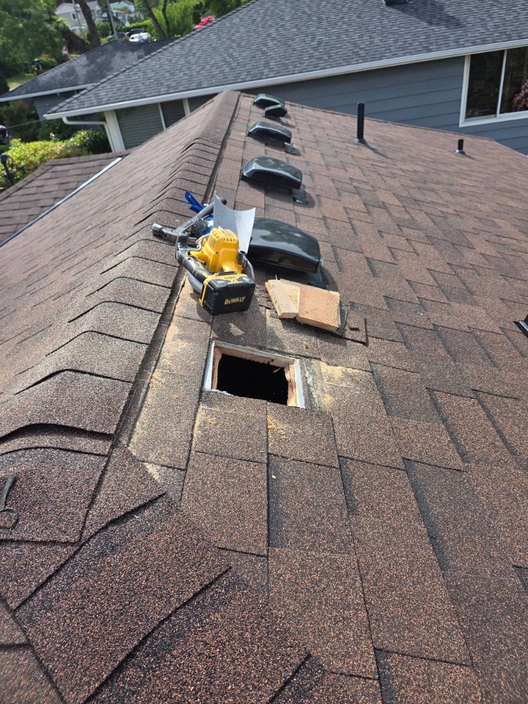 Crew working around roof vents and penetrations