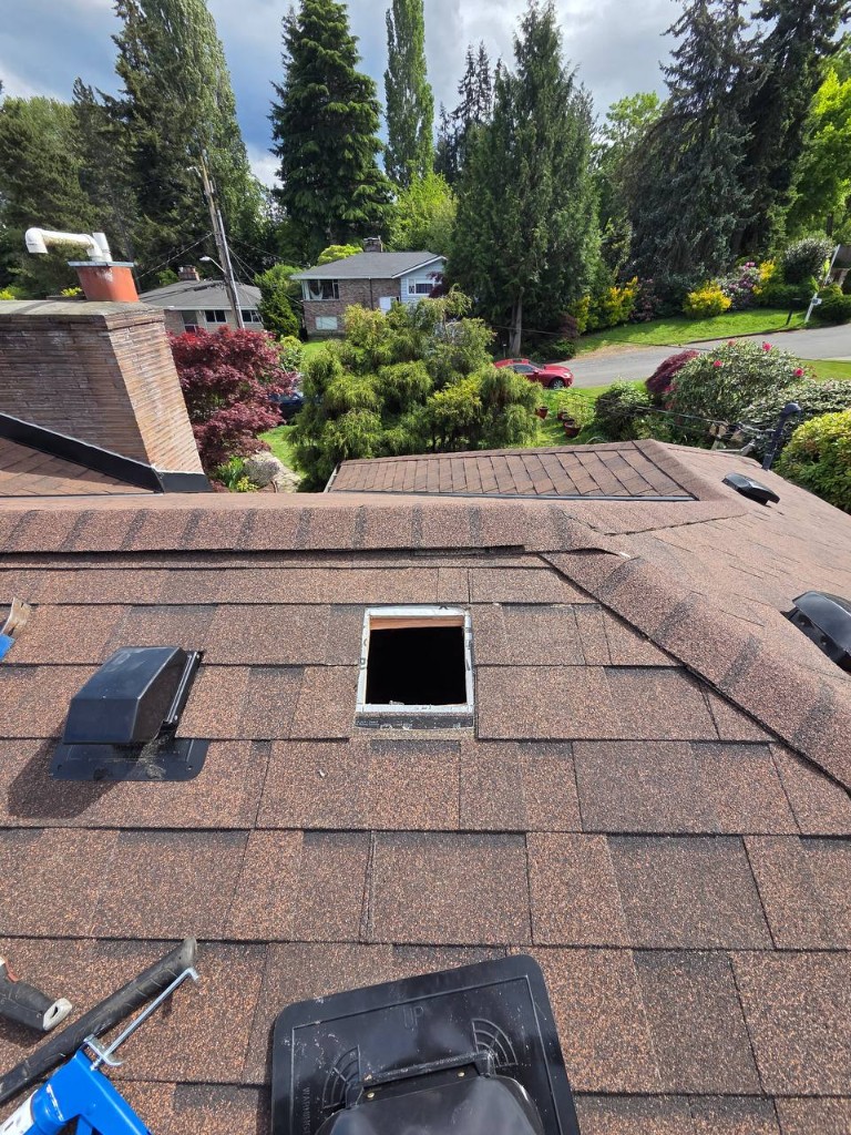 Skylight opening and flashing preparation on a shingle roof