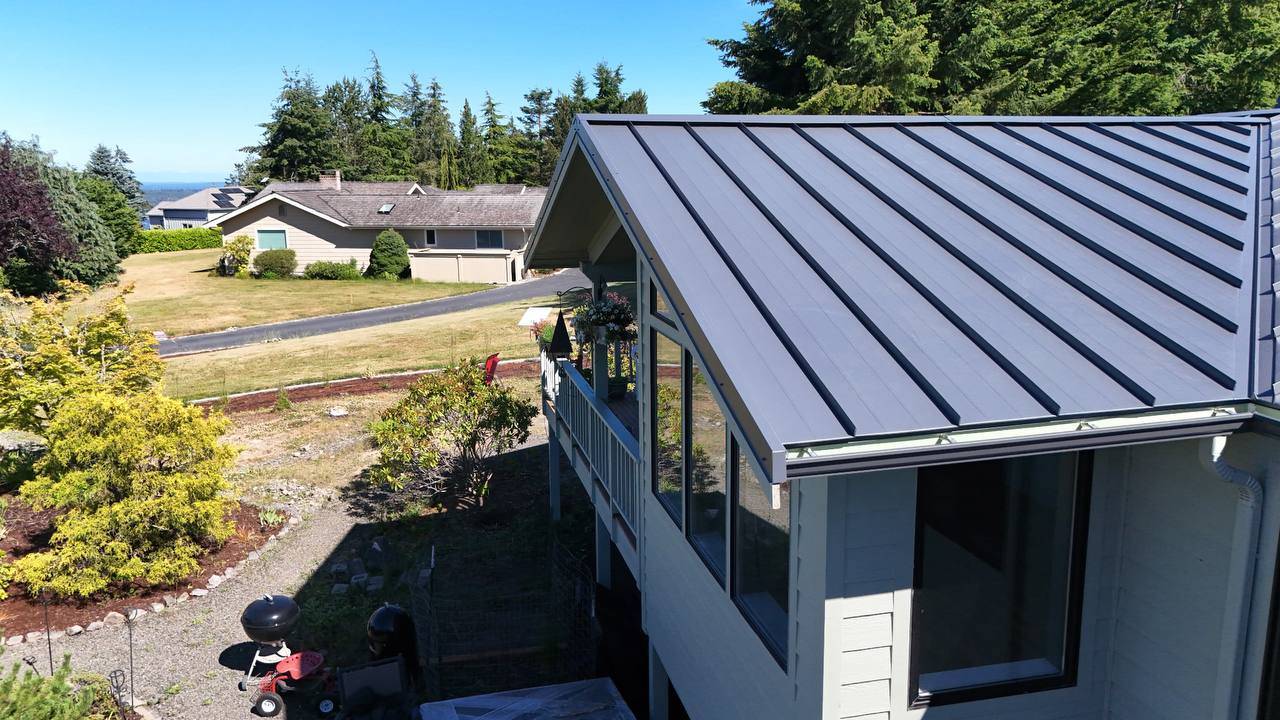 Standing seam metal roof with skylight and vent pipe boots in Bothell