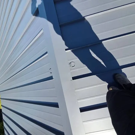 Standing seam metal roof on a wood-sided residential home