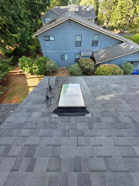 Skylight flashing on charcoal architectural shingles
