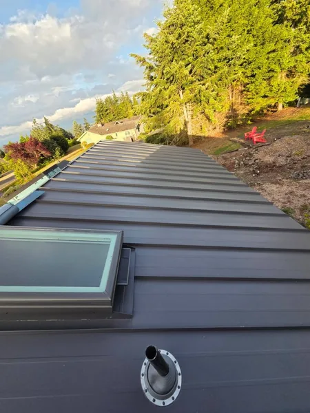 Standing seam metal roof valley detail with integrated skylight flashing