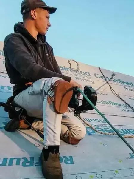 Roofing contractors replacing wind-damaged shingles