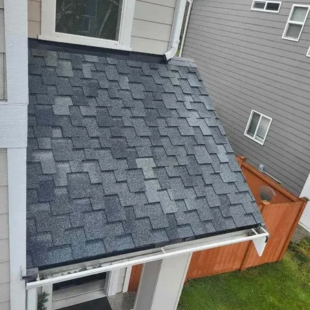 Residential roofing crew on a pitched home