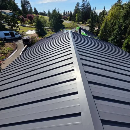 Drone photo of charcoal standing seam metal roof with deck
