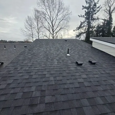 Crew installing shingles during a Western Washington winter project