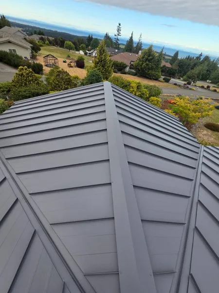 Standing seam metal roof panels during active installation on a residential project