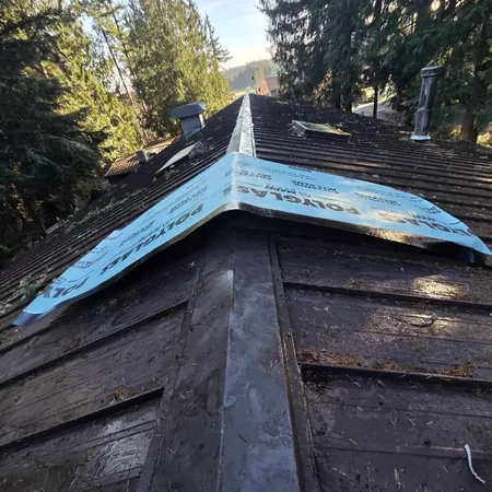 Temporary Polyglass membrane seal on a wet roof ridge