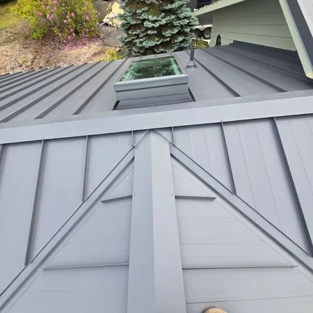 Dark gray panel roof with vent flashing
