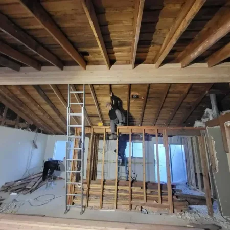 Licensed crew repairing wind-damaged shingles