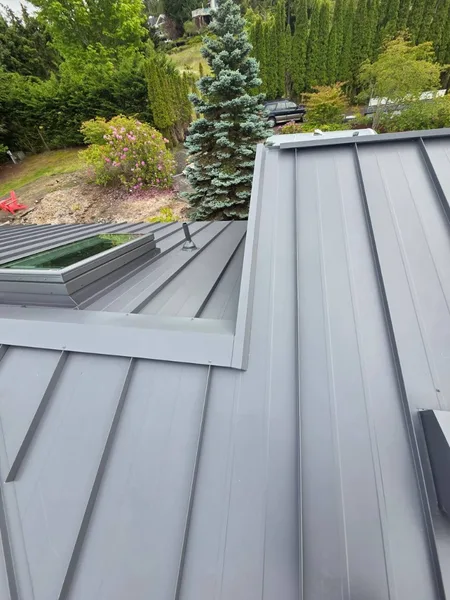 Metal roof crew working on ridge flashing with DeWalt tools on site