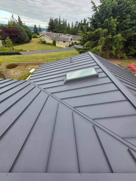 Standing seam metal roof with skylight and vent pipe boots in King County