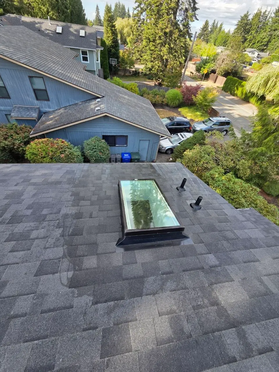 Charcoal shingle roof skylight and plumbing vents