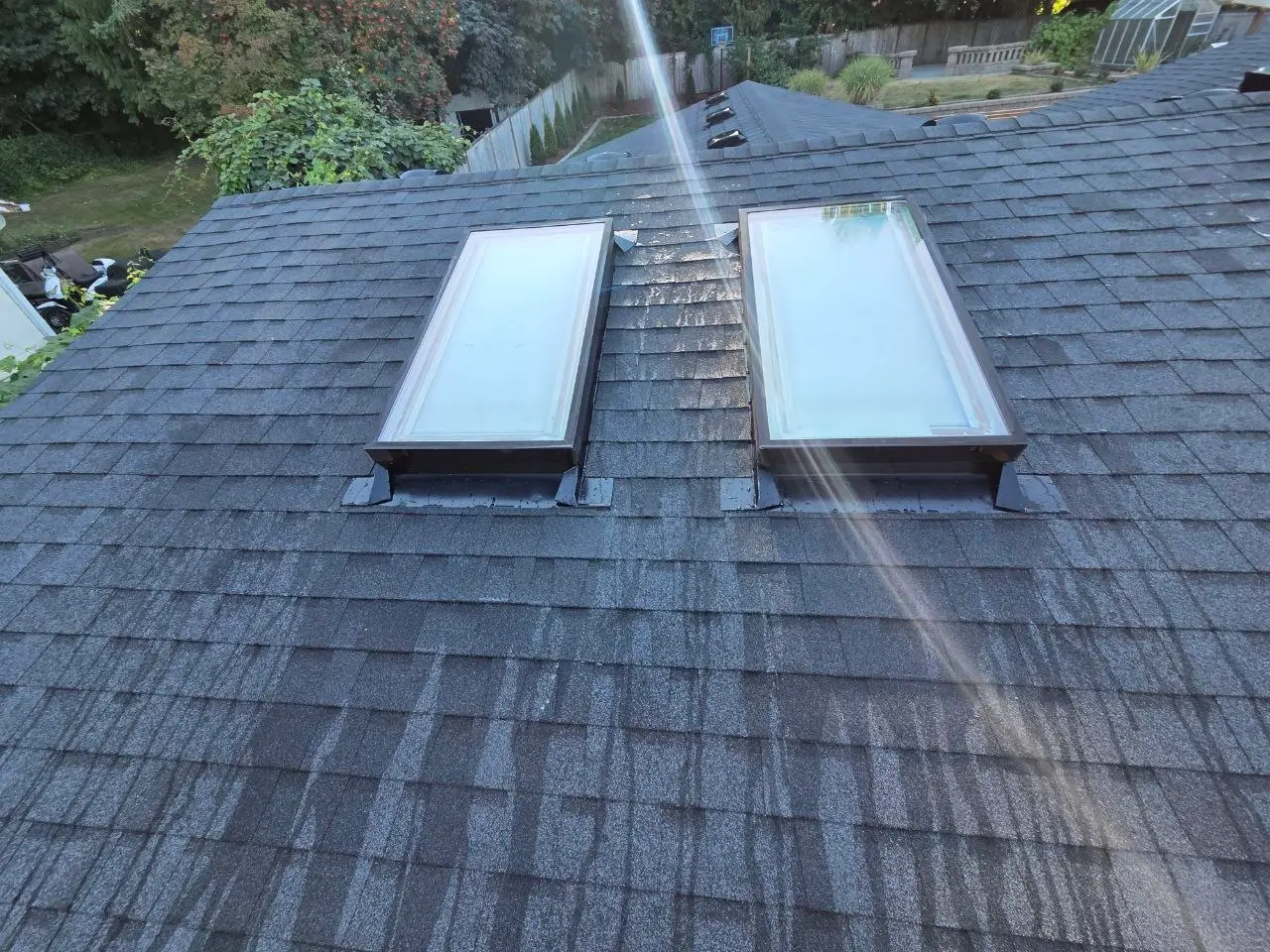 Dual skylight installation dark architectural shingles in Seattle