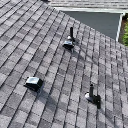 Roof vent detail on a repaired residential shingle roof