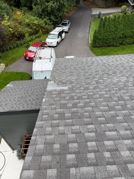 On-site roof leak repair with Construction Elite crew van
