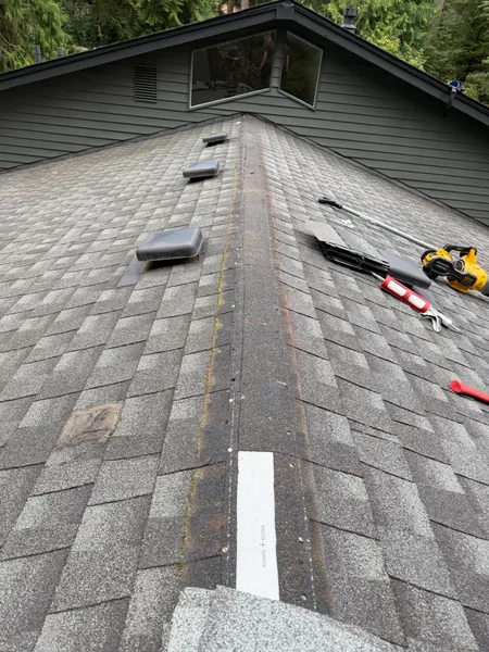 Open ridge during roof leak repair in progress