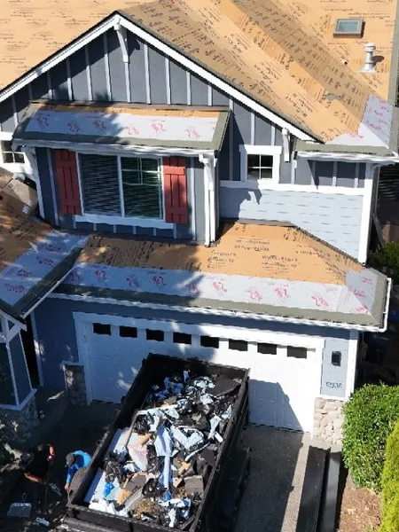 Aerial job-site view during residential shingle roof installation