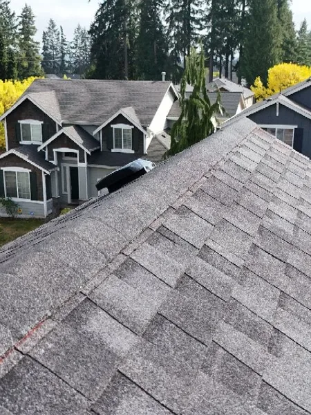 Aerial view of a multi-plane residential shingle roof installation