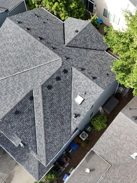 Drone view of a fully replaced gray architectural shingle roof
