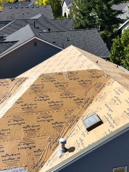 Ice-and-water underlayment prep across peaks before new shingles