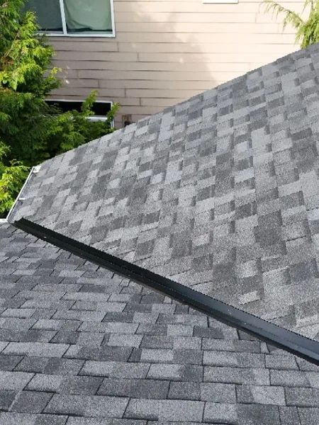 Clean ridge line detail on a newly replaced shingle roof