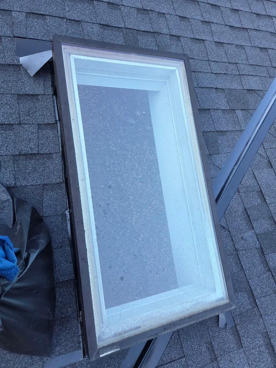 Skylight close up during shingle roof install in Everett