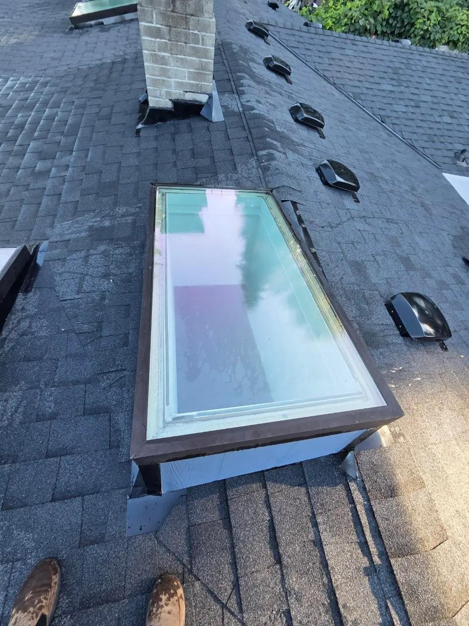 Skylight install charcoal shingles chimney vents in Bellevue