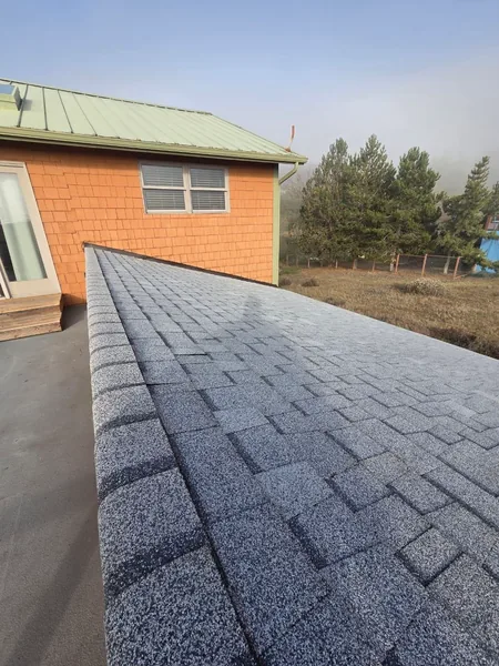 Finished gray architectural shingles on a residential slope