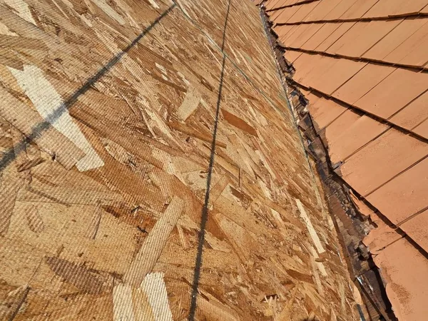 New roof sheathing beside cedar sidewall shingles