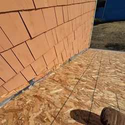 New roof decking butted to cedar siding