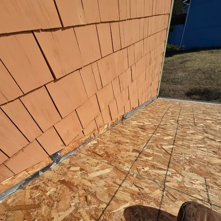 New roof deck meeting cedar sidewall shingles
