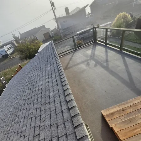 Architectural shingles meeting a low-slope deck