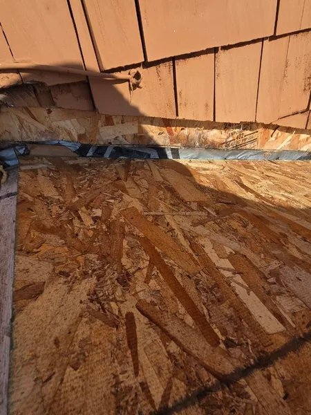New sheathing and step flashing at a wall